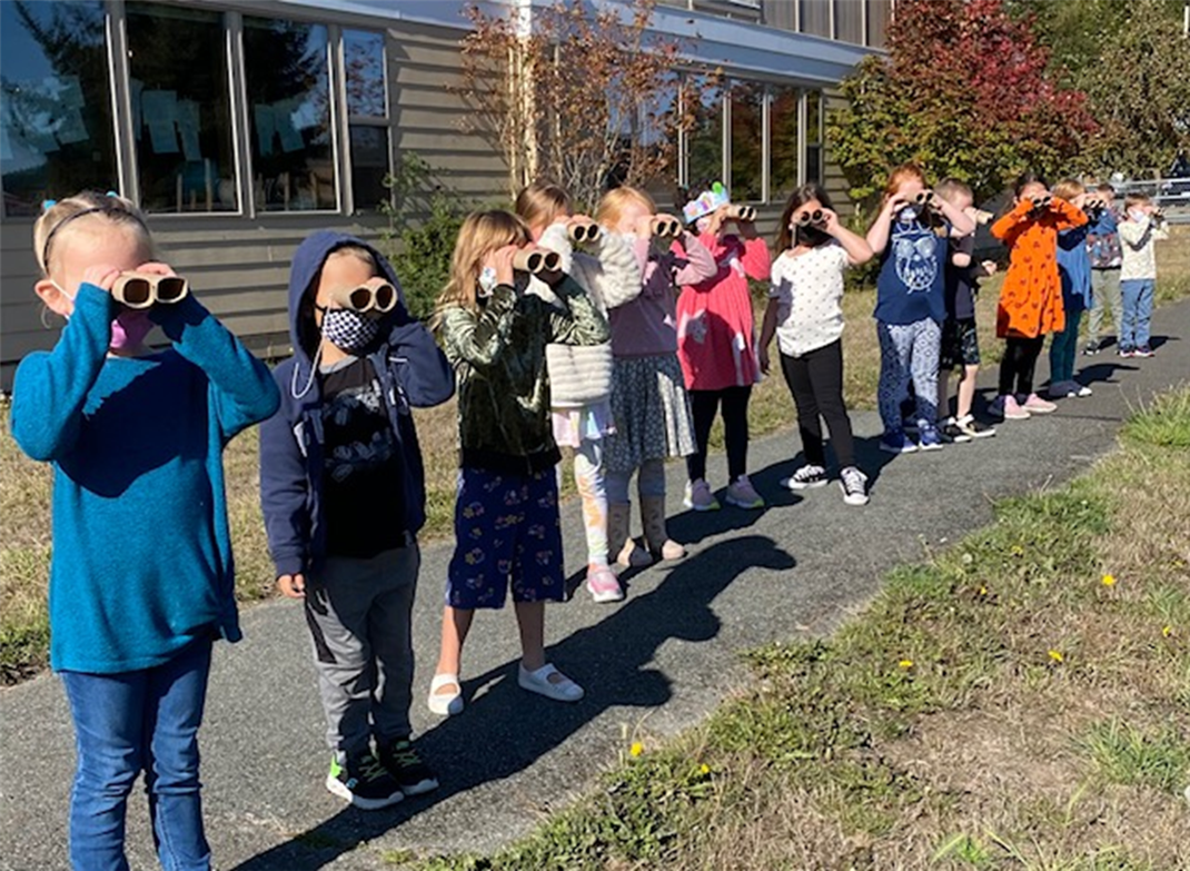 Elementary students with binoculars